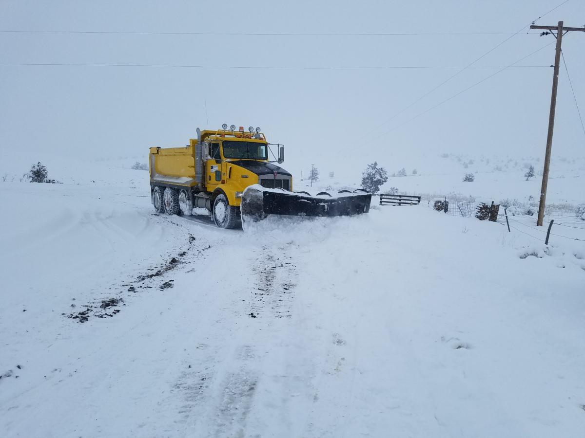 Dump truck with snow plow, plowing snow